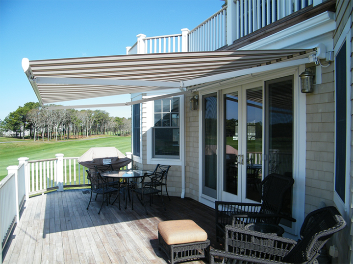 cream and brown striped awning extended over residential deck area